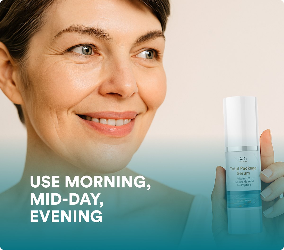 Smiling woman holding a bottle of Total Package Serum